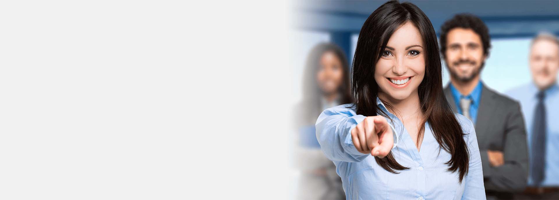 female smiling and point finger three colleagues in background