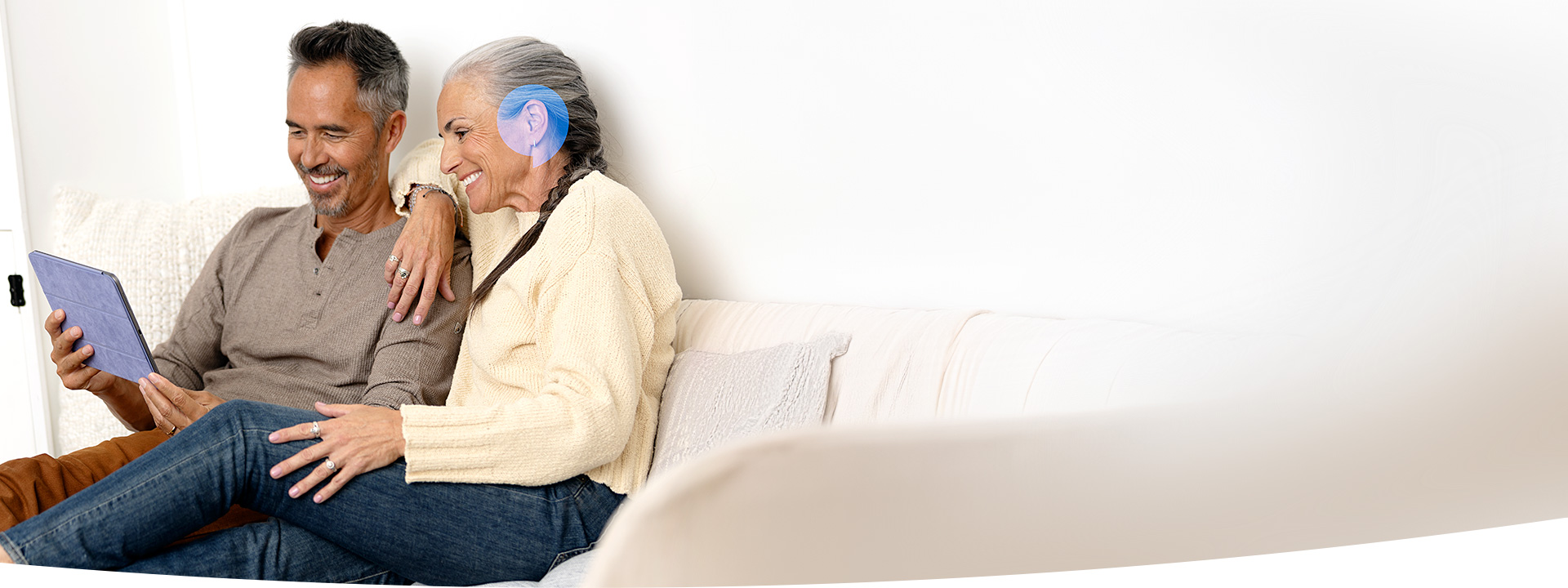 Image shows woman in front pf laptop with headphone on