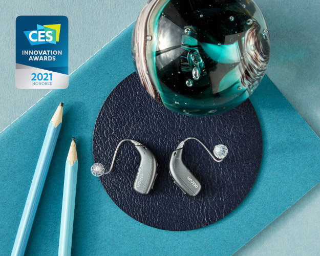 Image shows behind-the-ear hearing aids with other objects